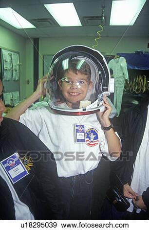 Stock Photo - Children try on spacesuit at Space Camp. Fotosearch