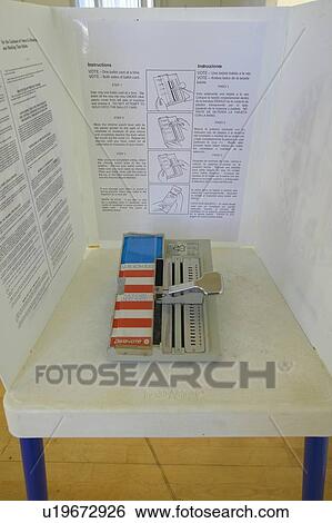 Stock Photograph - Close-up of a voting booth and ballot machine. Fotosearch