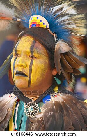 Stock Photograph - Close-up portrait of Native American in full regalia dancing at Pow wow. Fotosearch