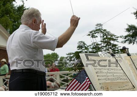 Stock Image - Conductor leading band. Fotosearch