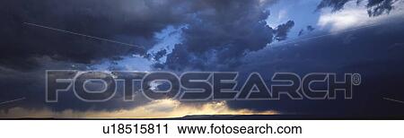 Dark clouds over the mountains of the Southwest. Sunlight on horizon starting to clear in western sky. View Large Photo Image Stock Image - Dark clouds over the mountains of the Southwest. Sunlight on horizon starting to clear in western sky.. Fotosearch