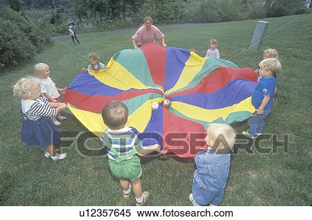 Daycare children playing a parachute game View Large Photo Image Stock Photography - Daycare children playing a parachute game. Fotosearch