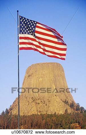 Stock Image - Devil's Tower National Monument and an American Flag, Wyoming. Fotosearch