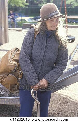 Elderly homeless woman holding cane View Large Photo Image Stock Image - Elderly homeless woman holding cane. Fotosearch