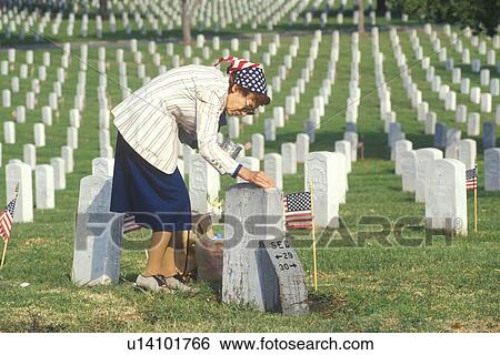 Stock Photograph - Elderly Woman Cleaning Grave, Los Angeles, California. Fotosearch