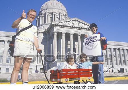 Stock Photo - Family at women's rights rally holding signs, State Capitol Building, Missouri. Fotosearch