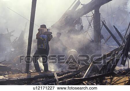 Stock Photo - Family salvaging possessions after riots. Fotosearch