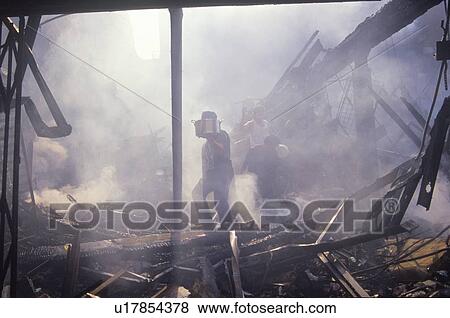 Stock Photo - Family salvaging possessions after riots. Fotosearch