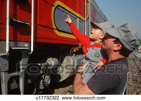 Father and son looking at historic trains View Large Photo Image Stock Image - Father and son looking at historic trains. Fotosearch
