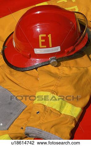 Firefighter's red helmet and yellow jacket View Large Photo Image Stock Image - Firefighter's red helmet and yellow jacket. Fotosearch