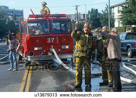 Stock Image - Firefighters with a witness. Fotosearch
