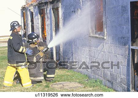 Firemen putting out a house on fire View Large Photo Image Stock Photograph - Firemen putting out a house on fire. Fotosearch