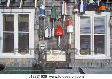 Stock Photo - Floats from fishing nets hang on the side of a lighthouse. Fotosearch