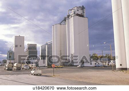 Stock Image - Grain silo with cloudy skies. Fotosearch