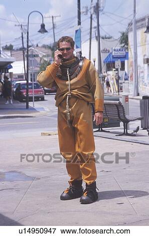 Greek sponge diver talks on cell phone with historic diving suit View Large Photo Image Stock Photo - Greek sponge diver talks on cell phone with historic diving suit. Fotosearch