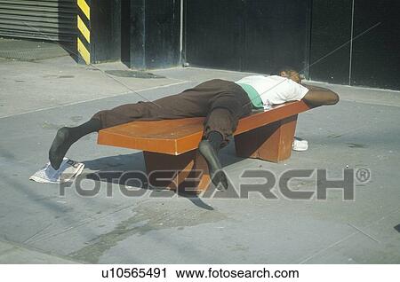 Homeless black man sleeping on a park bench View Large Photo Image Stock Image - Homeless black man sleeping on a park bench. Fotosearch