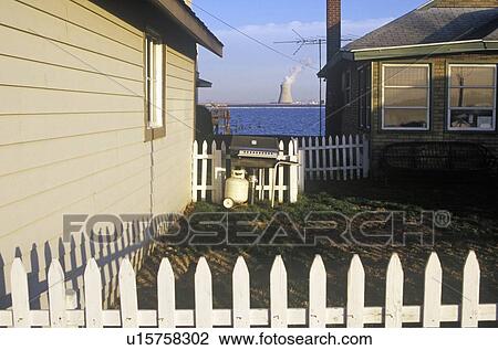 Stock Image - Homes with Power Plant in background. Fotosearch