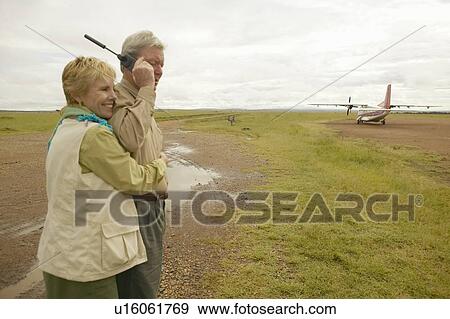 John and Melody Taft making a phone call on Satellite phone in Kenya Africa View Large Photo Image Stock Photo - John and Melody Taft making a phone call on Satellite phone in Kenya Africa. Fotosearch