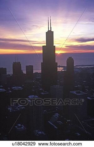 Stock Photo - John Hancock Building towers above Chicago Skyline at Sunrise, Chicago, Illinois. Fotosearch