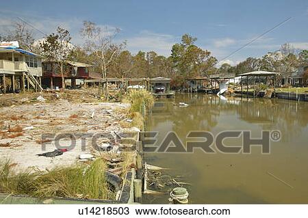 Stock Image - Lagoon and debris in front of house heavily hit by Hurricane Ivan in Pensacola Florida. Fotosearch