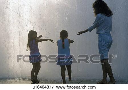 Stock Photo - Little girls playing in fountain. Fotosearch
