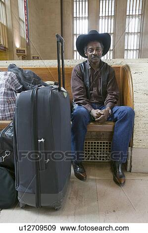 Man in cowboy hat waiting at train station View Large Photo Image Stock Photo - Man in cowboy hat waiting at train station. Fotosearch