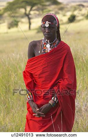 Masai Warrior in red surveying landscape View Large Photo Image Stock Image - Masai Warrior in red surveying landscape. Fotosearch