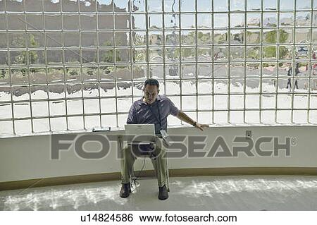 Media personnel working on laptop computer View Large Photo Image Stock Photograph - Media personnel working on laptop computer. Fotosearch