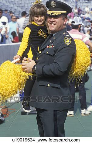 Picture - Military Officer with Little Girl at Football Game. Fotosearch