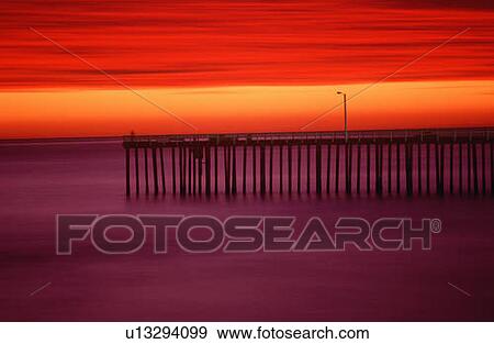 Morro Bay pier with brilliant red sky at sunset View Large Photo Image Stock Photo - Morro Bay pier with brilliant red sky at sunset. Fotosearch