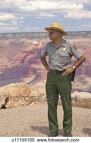 Stock Image - National Park ranger looking at South Rim of Grand Canyon National Park. Fotosearch