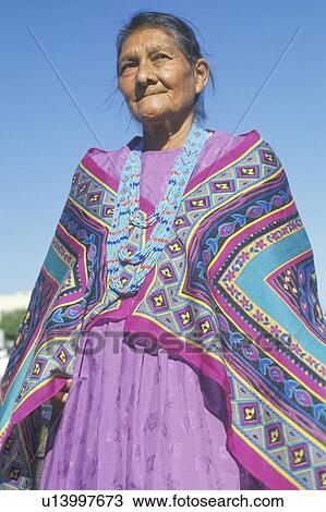 Stock Image - Native American Navajo woman in colorful beads and shawl. Fotosearch