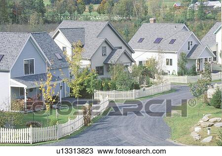 Stock Image - New England neighborhood with white picket fences. Fotosearch