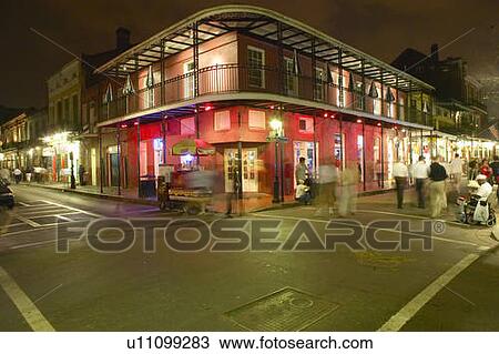 Stock Image - Night life with lights on Bourbon Street in French Quarter New Orleans, Louisiana. Fotosearch