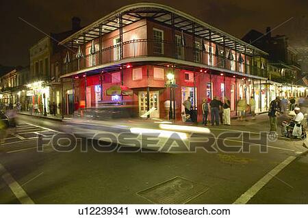 Stock Image - Night life with lights on Bourbon Street. Fotosearch