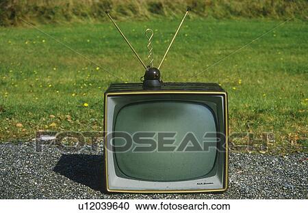 Stock Image - Old retro television set with rabbit ears antennae. Fotosearch