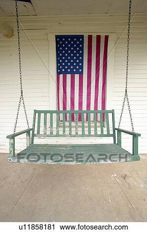 Old swing on porch displaying an American Flag View Large Photo Image Stock Image - Old swing on porch displaying an American Flag. Fotosearch