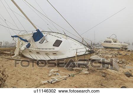 Overturned sailboat in wake of Hurricane View Large Photo Image Stock Image - Overturned sailboat in wake of Hurricane. Fotosearch
