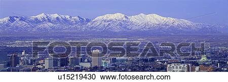Stock Image - Panoramic sunset of Salt Lake City with snow capped Wasatch Mountains. Fotosearch