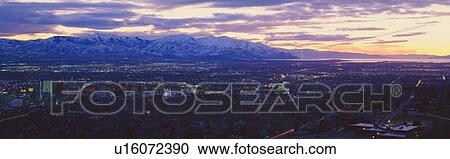 Stock Image - Panoramic sunset of Salt Lake City with snow capped Wasatch Mountains. Fotosearch