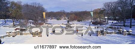 Stock Photo - Panoramic view of water fountain covered with fresh winter snow. Fotosearch