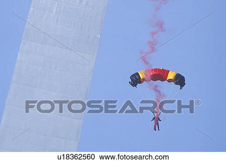Stock Image - Parachutist over arch with smoke, St. Louis, Missouri. Fotosearch