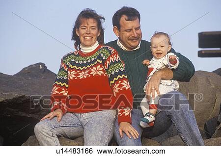 Stock Photograph - Parents and their baby at the beach. Fotosearch