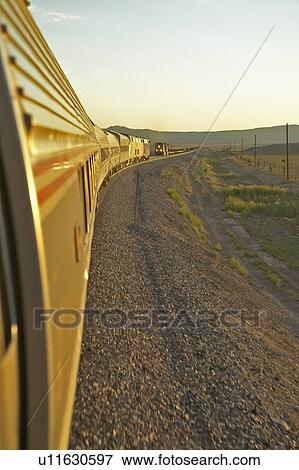 Stock Photo - Passenger train traveling into the Arizona sunset. Fotosearch