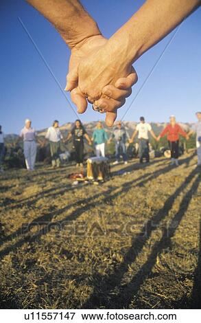 Stock Photo - People Holding Hands, Sunset Ceremony for Earth, Big Sur, California. Fotosearch