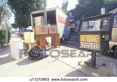 Stock Image - People move out of their damaged apartment. Fotosearch