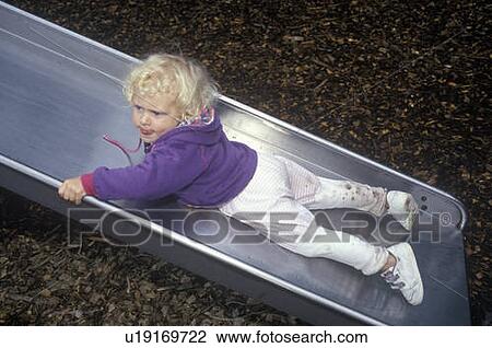 Preschooler on slide at pre-school View Large Photo Image Stock Image - Preschooler on slide at pre-school. Fotosearch