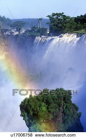 Stock Photo - Rainbow over Iguazu Waterfalls. Fotosearch