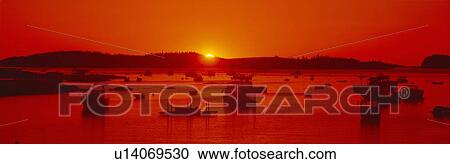 Stock Image - Red sunrise at Lobster Village, Stonington, Maine. Fotosearch