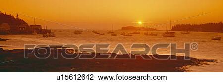 Stock Image - Red sunrise at Lobster Village, Tenants Harbor, Maine. Fotosearch